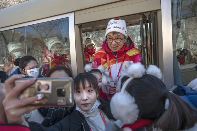 Actor Jackie Chan poses with student performers after participating in a leg of the Beijing 2022 Winter Olympics Torch Relay at the Badaling Great Wall on February 3, 2022 outside Beijing, China. (Photo by Kevin Frayer/Getty Images)