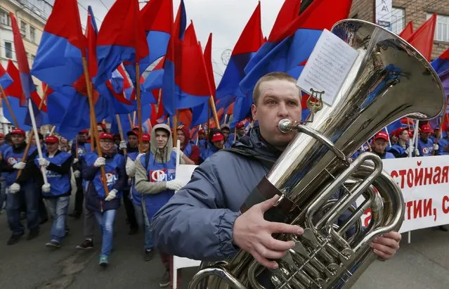 An orchestra musician plays during a May Day rally in Krasnoyarsk, Siberia, Russia, May 1, 2016. (Photo by Ilya Naymushin/Reuters)