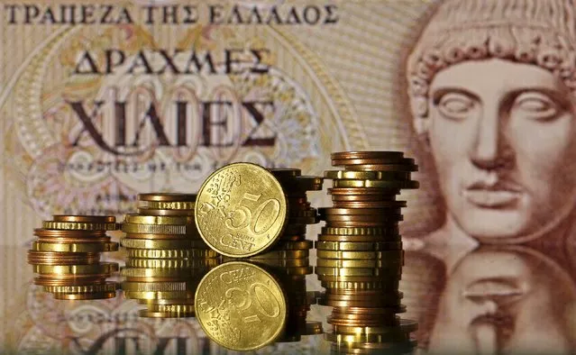 Euro coins are seen in front of a displayed of Head of Apollo on 1.000 Drachma old Greece banknote in this photo illustration taken in Zenica, Bosnia and Herzegovina, June 30, 2015. (Photo by Dado Ruvic/Reuters)
