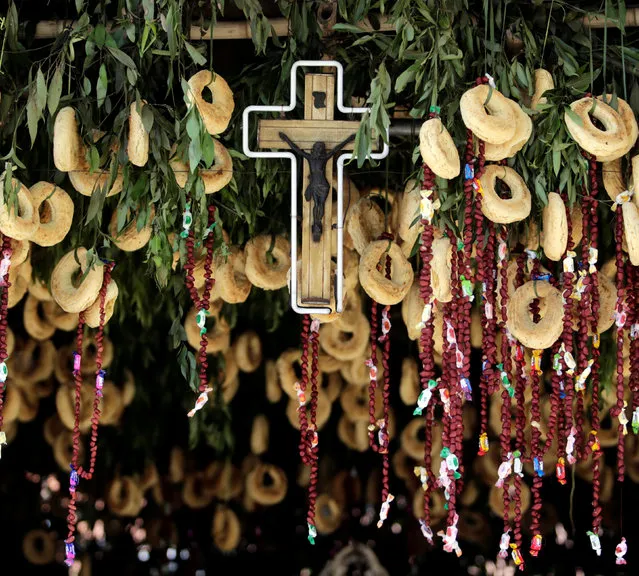 An altar is pictured after it was decorated by the Antar family with some 3,000 traditional cheese and corn buns called chipas, in celebration of the Catholic festival Kurusu Ara (The Day of the Cross), in Asuncion, Paraguay May 3, 2016. (Photo by Jorge Adorno/Reuters)