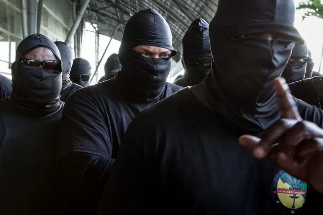 Members of The 500 Brothers look on during a protest in support of the general strike on March 29, 2017 in Cayenne, French Guiana. Life in French Guiana was severely disrupted by a general strike that closed schools and shops and stoked fears of further instability in one of France' s overseas territories. The French government appealed for calm in the South American territory which has been gripped by protests since last week over security and the state of the economy. (Photo by Jody Amiet/AFP Photo)