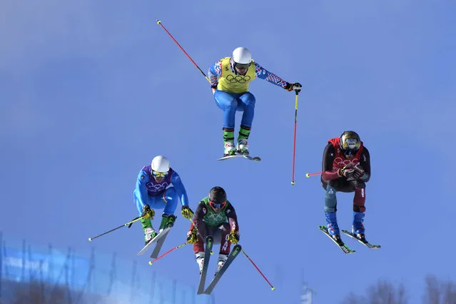 Switzerland's Alex Fiva, right, leads the pack, followed by Sergey Ridzik, of the Russian Olympic Committee, Italy's Simone Deromedis and Canada's Brady Leman, competes during the men's cross finals at the 2022 Winter Olympics, Friday, February 18, 2022, in Zhangjiakou, China. (Photo by Lee Jin-man/AP Photo)
