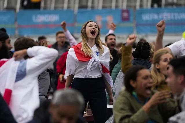 England fans celebrate their team's second goal as they watch the Euro 2020 round of 16 soccer championship match between England and Germany being played at London's Wembley stadium, at a fan zone in central Trafalgar Square in London, Tuesday, June 29, 2021. England won 2-0. (Photo by Matt Dunham/AP Photo)