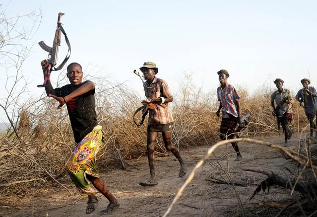 Turkana warriors react as they hear that Nyangatom warriors are around their settlement in Ilemi Triangle, Kenya, July 17, 2019. (Photo by Goran Tomasevic/Reuters)