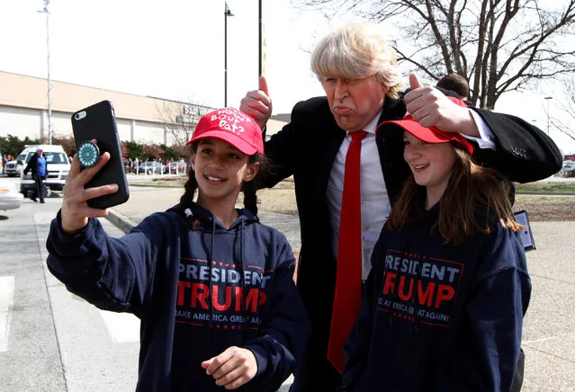 Trump fans take selfies with a Donald Trump impersonator outside the Kentucky State Fairgrounds as they wait for U.S. Presidential Donald Trump to arrive for a campaign stop in Louisville, Kentucky,  March 20, 2017. (Photo by John Sommers II/Reuters)