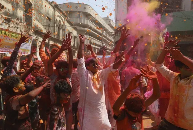 People celebrate Holi, the Hindu festival of colors, in Hyderabad, India, Thursday, March 17, 2022. Holi also heralds the arrival of spring. (Photo by Mahesh Kumar A./AP Photo)