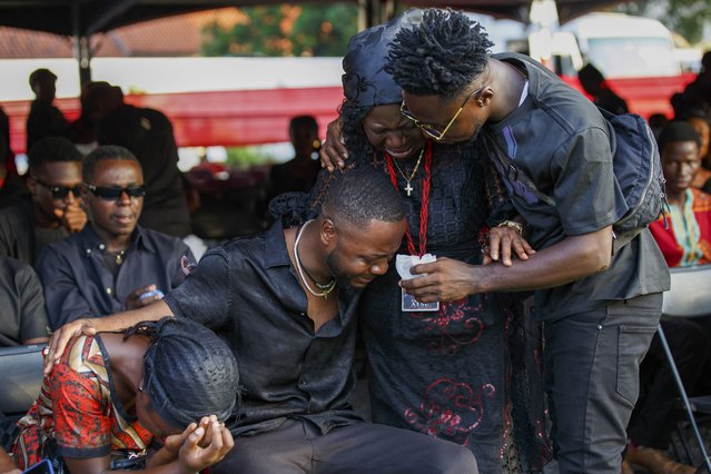 Relatives of Ghana soccer player Christian Atsu weep during his funeral at the State House in Accra, Ghana, Friday, March 17, 2023. Atsu, who played for Premier League teams Chelsea and Newcastle, before joining Turkish club Hatayspor last year, was found dead in his collapsed apartment building in the Turkey earthquake. (Photo by Misper Apawu/AP Photo)