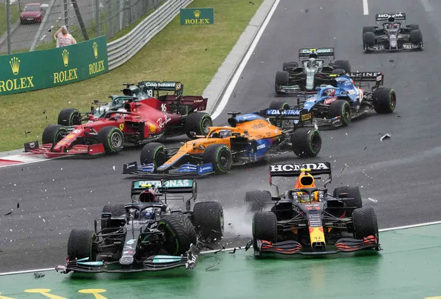 Mercedes driver Valtteri Bottas of Finland, left, and Red Bull driver Sergio Perez of Mexico crash during the Hungarian Formula One Grand Prix at the Hungaroring racetrack in Mogyorod, Hungary, Sunday, August 1, 2021. (Photo by Darko Bandic/AP Photo)