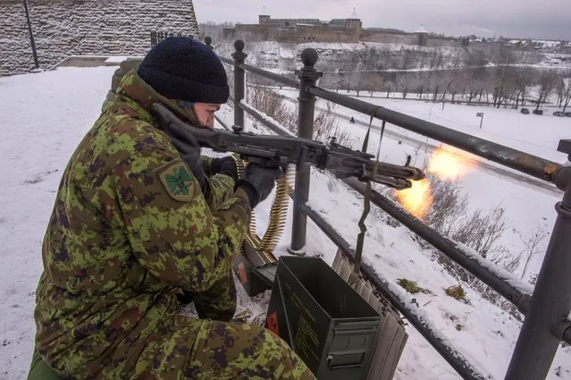 Picture taken on January 14, 2017 shows an Estonian Kaitseliit paramilitary volunteer firing a machine gun in Narva, Estonia. Like other east Europeans, Estonians were deeply disturbed by Russia's 2014 annexation of Crimea and its subsequent support for separatists in eastern Ukraine. US President-elect Donald Trump then raised more concerns with his campaign threat to think twice about defending NATO's eastern allies. These factors coupled with Kremlin sabre rattling in the Baltic region – especially in its heavily militarised Kaliningrad exclave – have triggered a paramilitary revival in eastern European states that were under Moscow's thumb during the Soviet era. (Photo by Raigo Pajula/AFP Photo)