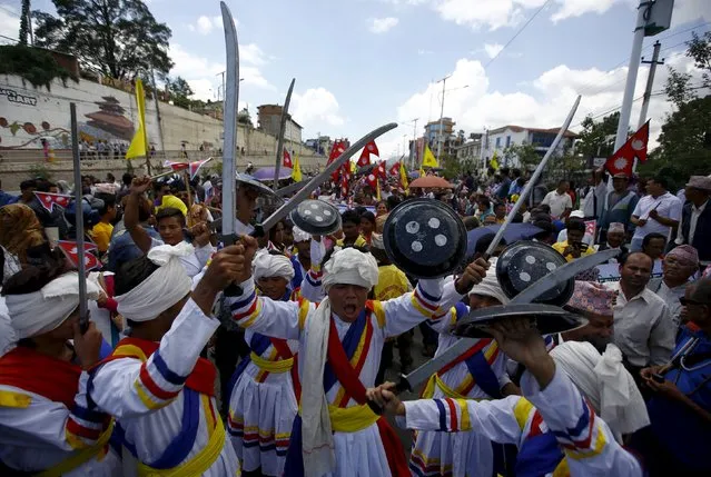 Hindu activists holding wooden swords take part in the protest rally marching towards the parliament demanding Nepal to be declared as Hindu State in the new constitution, in Kathmandu August 3, 2015. (Photo by Navesh Chitrakar/Reuters)