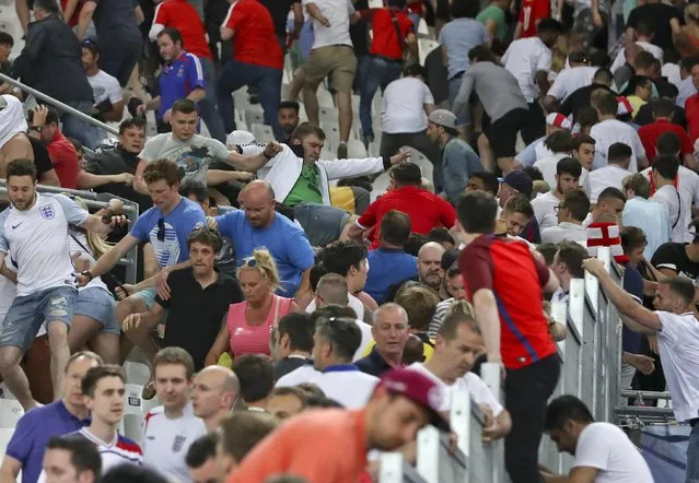 Spectators run on the stands as clashes break out right after the Euro 2016 Group B soccer match between England and Russia, at the Velodrome stadium in Marseille, France, Saturday, June 11, 2016. (Photo by Thanassis Stavrakis/AP Photo)