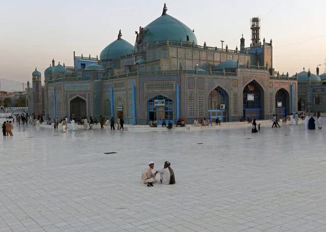 Men sit in the yard of the shrine of Imam Ali, son in-law of Prophet Mohammad, in the city of Mazar-i-Shariff, northern Afghanistan, July 29, 2015. (Photo by Mohammad Ismail/Reuters)