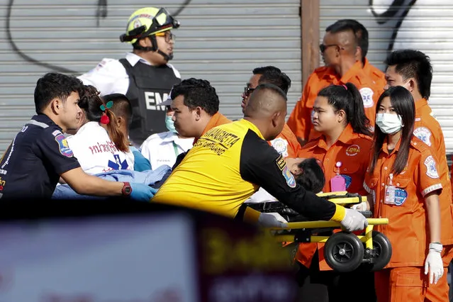 Medics transport a victim on a stretcher at the scene of a mass shooting at the Terminal 21 shopping mall in Nakhon Ratchasima, Thailand, 09 February 2020. (Photo by Rungroj Yongrit/EPA/EFE)