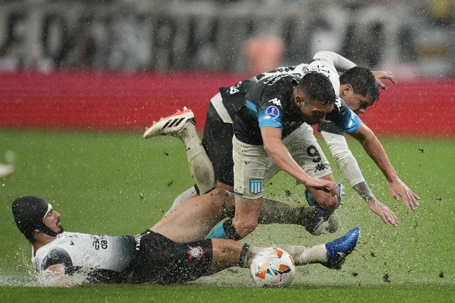 Andre Ramalho of Brazil's Corinthians tackles Juan Nardoni of Argentina's Racing Club during a Copa Sudamericana semifinal first leg soccer match at Neo Quimica arena in Sao Paulo, Thursday, October 24, 2024. (Photo by Andre Penner/AP Photo)