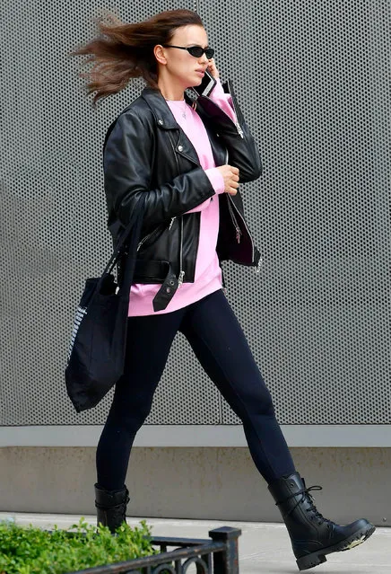 Irina Shayk is spotted with windswept hair in New York City on March 13, 2020. The Russian supermodel wore a black leather motorcycle jacket, pink sweatshirt, black leggings, and Christian Dior rubber boots. (Photo by TheImageDirect.com)