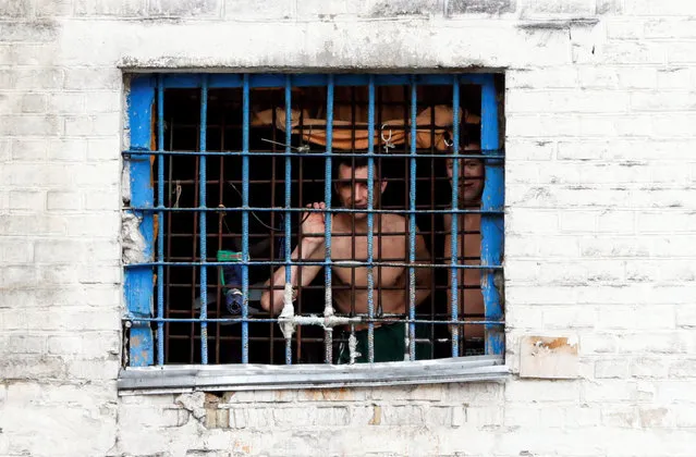 Detainees look out from a prison cell at a compound of the Lukyanivska detention centre in Kiev, Ukraine, July 19, 2016. (Photo by Valentyn Ogirenko/Reuters)