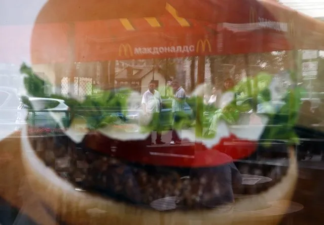 People are reflected in a window of a closed McDonald's restaurant, one of four temporarily closed by the state food safety watchdog, in Moscow, August 21, 2014. Russia ordered the temporary closure of four McDonald's restaurants in Moscow on Wednesday, a decision it said was over sanitary violations but which comes against a backdrop of worsening U.S.-Russian ties over Ukraine. (Photo by Maxim Zmeyev/Reuters)