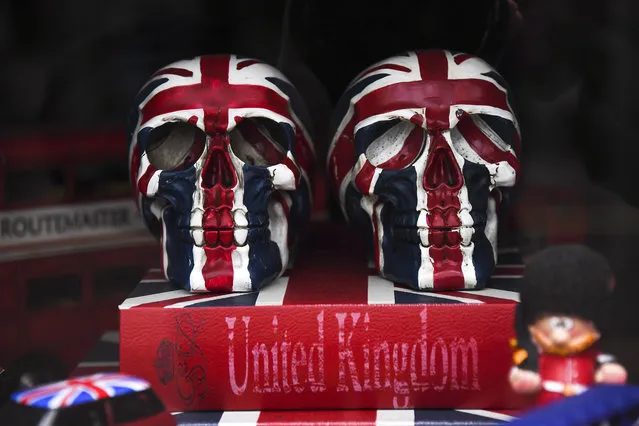In this Tuesday, April 28, 2020 file photo, two skulls painted in a Union Flag are displayed in a window of a closed souvenir shop in London, as the lockdown continues due to the coronavirus. Businesses across Europe, many with employees on temporary unemployment due to coronavirus restrictions, are waiting for government rules to ease before some can go back to work. (Photo by Alberto Pezzali/AP Photo/File)