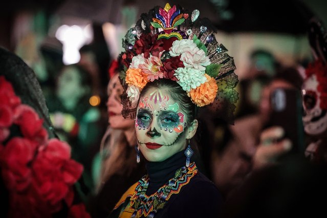 A woman with a typical make up of “Catrina” looks on during the Day of the Dead's Parade “El Dia de los muertos” with a procession of “Catrinas” organised by the Latino Mex association in Bordeaux, southwestern France, on November 2, 2023. (Photo by Thibaud Moritz/AFP Photo)
