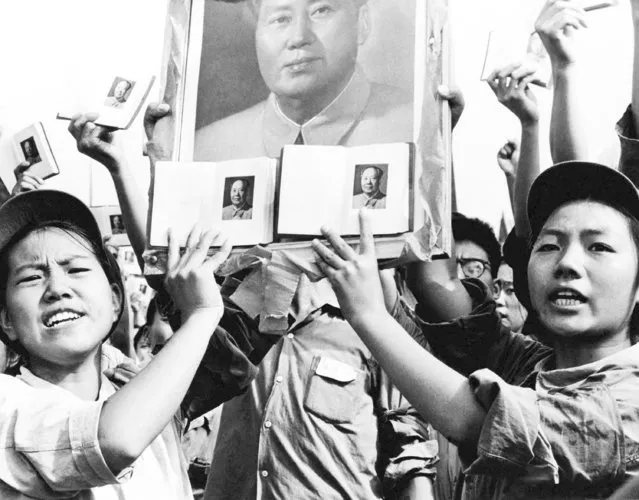 In this September 14, 1966, file photo, portraits of Mao Zedong, Chairman of the Chinese Communist Party, and books of his sayings, are held during a public rally held by the Red Guard in Beijing, formerly known as Peking. Since seizing power amid civil war in 1949, the party has undergone a tumultuous history, but president and party leader Xi Jinping is emphasizing the country’s rise to economic, military and diplomatic over the past four decades since reforms were enacted. (Photo by AP Photo/File)