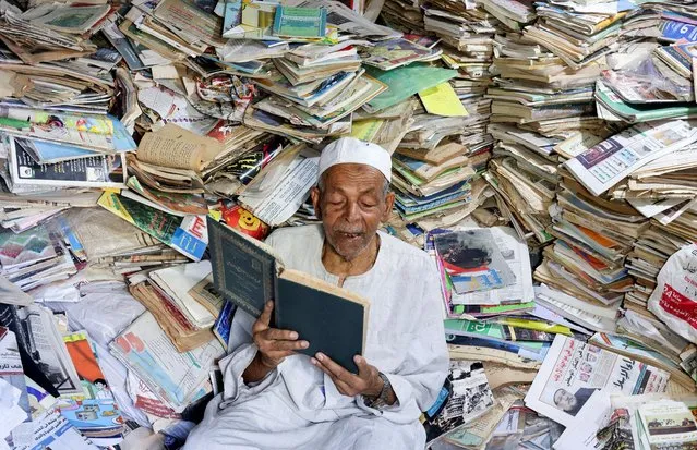 Abdallaa Abu Dawh, 82, a former teacher at Egypt's Al-Azhar university who now works as an imam, reads in a library at his basement home which contains some 15,000 books collected in the course of his life, in the hope of making an impact by offering young men and women in his village, in the Nile Delta, books to read for free in Dakahlia governorate, north of Cairo, Egypt on August 26, 2022. (Photo by Mohamed Abd El Ghany/Reuters)