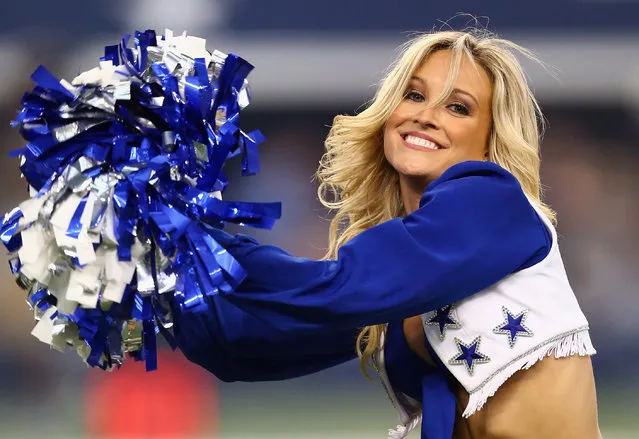 A Dallas Cowboys cheerleader performs during an NFL preseason game between the Baltimore Ravens and the Dallas Cowboys at AT&T Stadium on August 16, 2014 in Arlington, Texas. (Photo by Ronald Martinez/Getty Images)