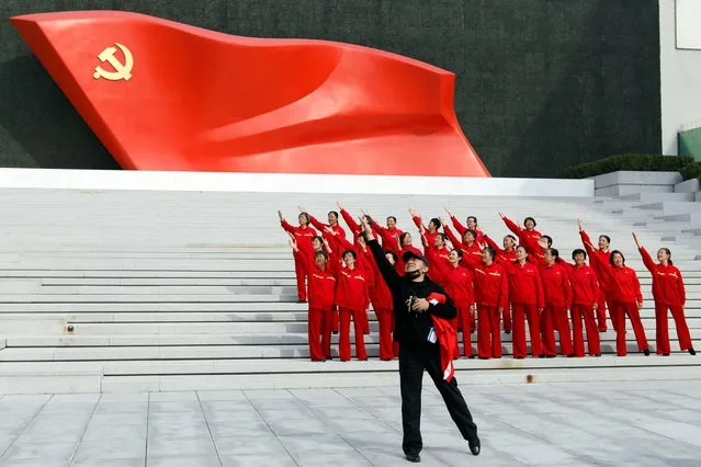 Visitors pose for a video in front of an installation of the Chinese Communist Party flag, at the Museum of the Communist Party of China in Beijing, China on October 13, 2022. (Photo by Florence Lo/Reuters)