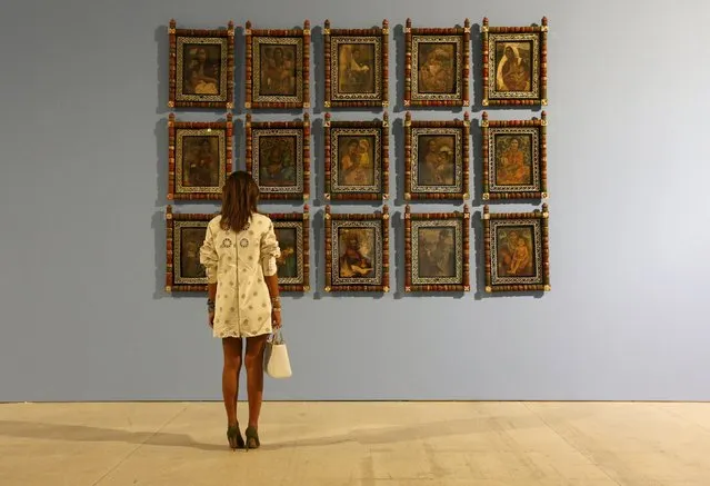 A woman looks at a series of portraits, which is on display at the exhibition “Our Land / Alien Territory” in Moscow, Russia, September 15, 2015. The main topic of the exhibition is the phenomenon of disputed territories and borderline areas facing persistent instability all over the world, according to local media. (Photo by Sergei Karpukhin/Reuters)