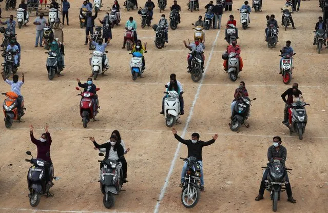 Faithful sit on their two-wheelers and pray as they attend a drive-in mass in an open area of Bethel AG Church as part of maintaining social distancing to prevent the spread of coronavirus in Bengaluru, India, Sunday, June 21, 2020. India is the fourth hardest-hit country by the COVID-19 pandemic in the world after the U.S., Russia and Brazil. (Photo by Aijaz Rahi/AP Photo)