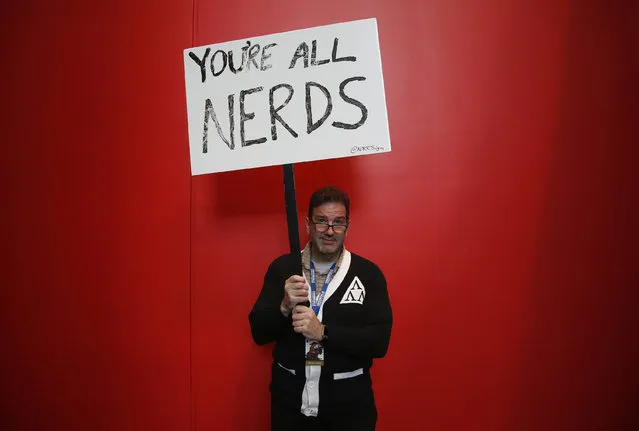 Brad Trechak, from New Jersey, holds a sign inside New York's Comic-Con convention, October 9, 2014. (Photo by Shannon Stapleton/Reuters)