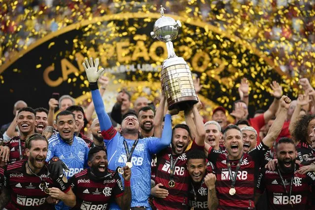 Brazil's Flamengo players celebrate with the trophy after winning the Copa Libertadores final soccer match against Brazil's Athletico Paranaense at the Monumental Stadium in Guayaquil, Ecuador, Saturday, October 29, 2022. (Photo by Fernando Vergara/AP Photo)