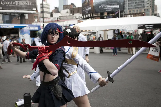 Costumed attendees pose inside New York's Comic-Con convention. (Photo by Siemond Chan)