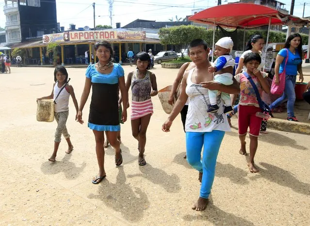 Colombian Nukak Maku Indian people walk on a street in San Jose del Guaviare of Guaviare province September 4, 2015. (Photo by John Vizcaino/Reuters)