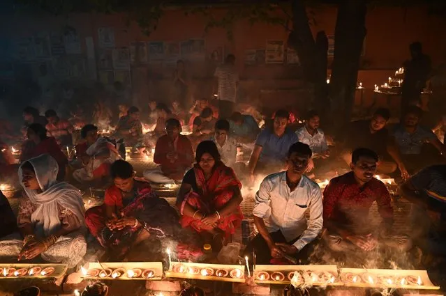 Hindu devotees offer prayers at the Shri Shri Lokanath Brahmachari temple during the Hindu religious fasting festival of “Rakher Upobash” in Narayanganj on November 8, 2022. (Photo by Munir Uz Zaman/AFP Photo)