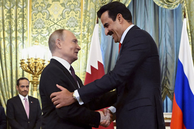 Russian President Vladimir Putin, left, and Qatar's Emir Sheikh Tamim bin Hamad Al-Thani, right, shake hands during their meeting at the Grand Kremlin Palace in Moscow, Russia, Thursday, April 17, 2025. (Photo by Alexander Nemenov/Pool Photo via AP Photo)