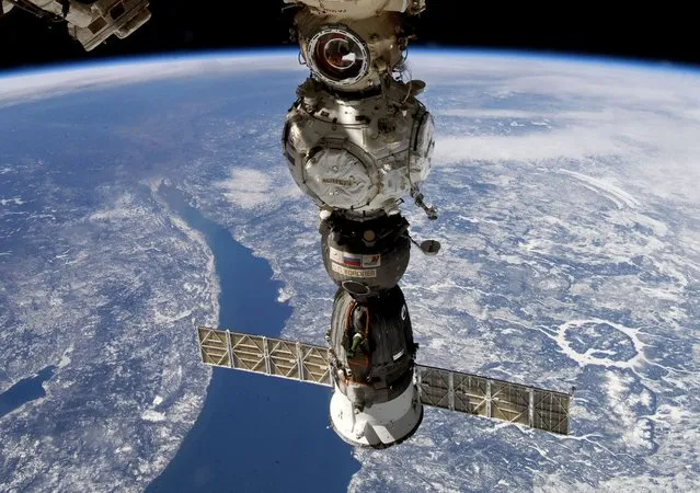 This undated handout photo taken by Russian cosmonaut Sergei Korsakov and released by Roscosmos State Space Corporation shows a Soyuz capsule of the International Space Station (ISS) during its fly. Russian space corporation Roscosmos said that a coolant leak from a Russian space capsule attached to the International Space Station that prompted a pair of Russian cosmonauts to abort a planned spacewalk was likely caused by a micrometeorite. (Photo by Sergei Korsakov, Roscosmos State Space Corporation via AP Photo)