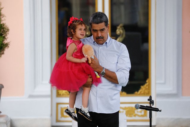 Venezuela's President Nicolas Maduro carries two-year-old Maikelys Espinoza Bernal, who remained in the U.S. following the deportation of her parents and was reunited with her mother yesterday, in Caracas, Venezuela, on May 15, 2025. (Photo by Leonardo Fernandez Viloria/Reuters)