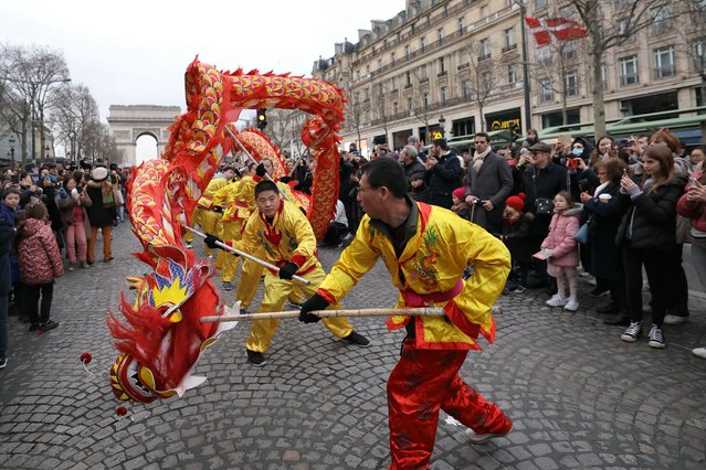 Members of the Chinese community perform the dragon dance during a parade to celebrate the Chinese Lunar New Year on the Champs-Elysees in Paris on February 4, 2024. Chinese Lunar New Year starts on February 10, 2024 and will be the year of the Dragon. (Photo by Thomas Samson/AFP Photo)