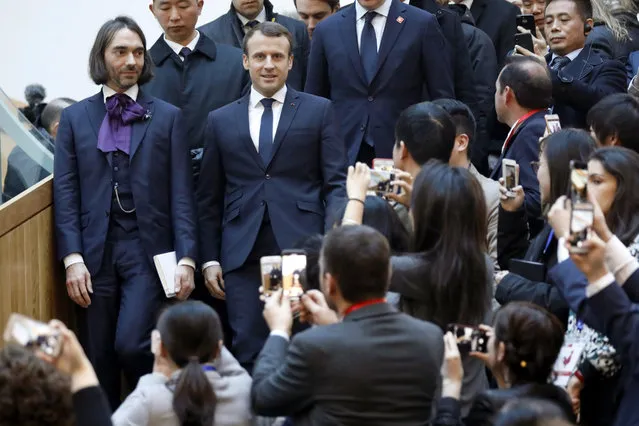 French President Emmanuel Macron, front right, is greeted by French mathematician and La Republique En Marche parliament member Cedric Villani, front left, before delivering his speech at the start-up incubator Soho3Q, in Beijing, Tuesday, January 9, 2018. (Photo by Charles Platiau/Pool Photo via AP Photo)