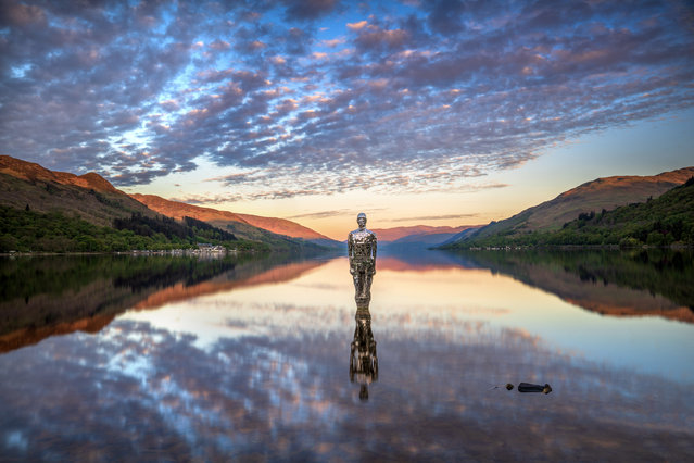 “Still” also known as the “Mirror Man”, created by artist Rob Mulholland which symbolises the physical and spiritual relationship between humans and the natural world, has returned to Loch Earn in St. Fillans on May 9, 2025 after being removed in 2017 due to storm damage. (Photo by Lesley Martin)
