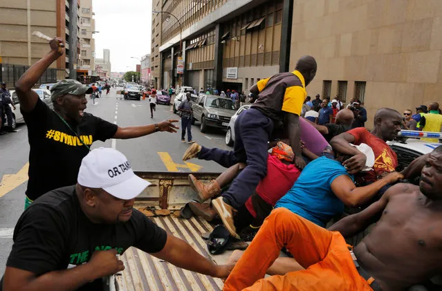 Members of the ANC (African National Congress) attack people on the back of a pick up truck whom they suspect of being members of the BLF (Black Land First) party, outside the ANC head offices in Johannesburg, South Africa, 05 February 2018. The ANC said it would protect its offices against any attacks by other parties. President Zuma has been under a cloud of controversy surrounding allegations of corruption. The highest ANC party officials have been meeting to consider the South African President's future. (Photo by Kim Ludbrook/EPA/EFE)