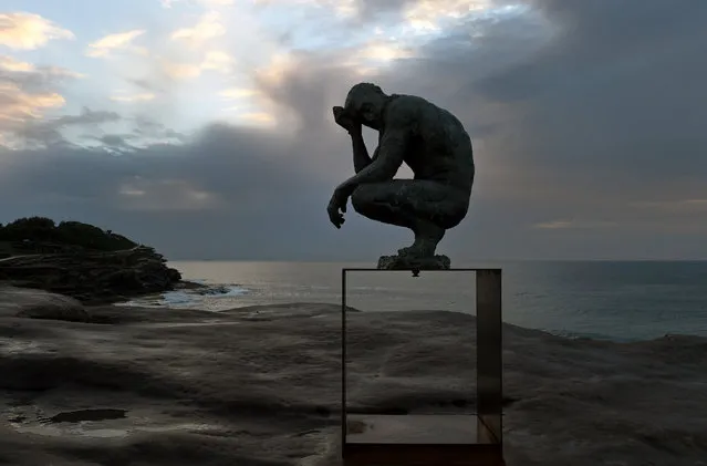 'Crouching Man' by artist Laurence Edwards as part of the annual Sculpture by the Sea along the Bondi Beach to Bronte Beach walk in Sydney, Australia, October 22, 2015. The exhibition runs from Oct. 22 to Nov. 8, 2015. (Photo by Dean Lewins/EPA)