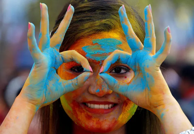 A student of Rabindra Bharati University, with her face smeared in coloured powder, poses during celebrations for Holi inside the university campus in Kolkata, India, February 26, 2018. (Photo by Rupak De Chowdhuri/Reuters)