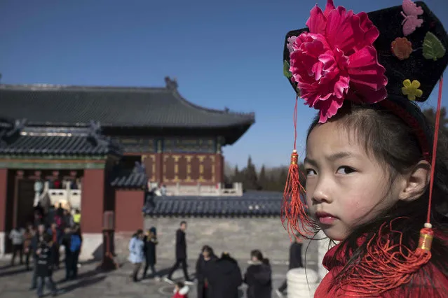 A girl visits the Temple of Heaven during the Lunar New Year holidays in Beijing on February 20, 2018. China is in the midst of a week-long holiday marking the beginning of the Year of the Dog. (Photo by Nicolas Asfouri/AFP Photo)