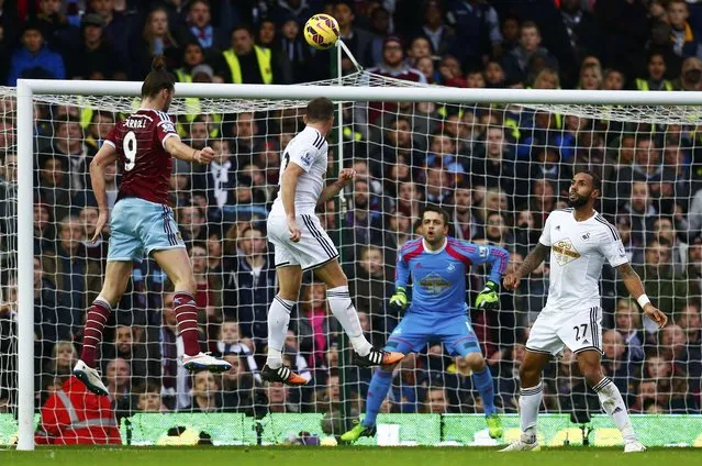 Andy Carroll of West Ham United heads to score against Swansea City during their English Premier League soccer match at Upton Park in London, December 7, 2014. (Photo by Eddie Keogh/Reuters)