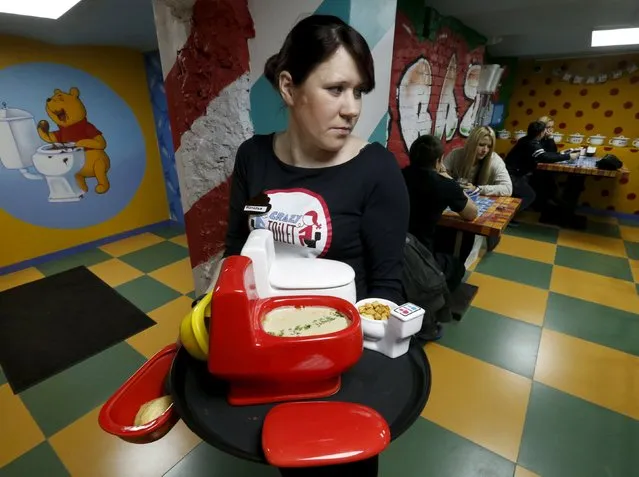 A waitress serves an order at Crazy Toilet Cafe in central Moscow, Russia October 30, 2015. (Photo by Sergei Karpukhin/Reuters)