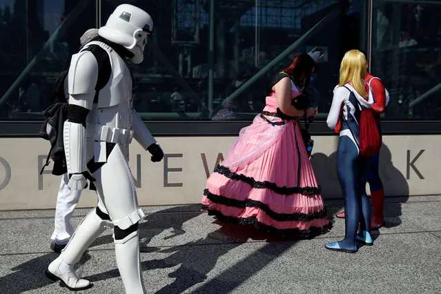 People dressed in costume are seen outside the New York Comic Con in New York, U.S., October 6, 2016. (Photo by Shannon Stapleton/Reuters)