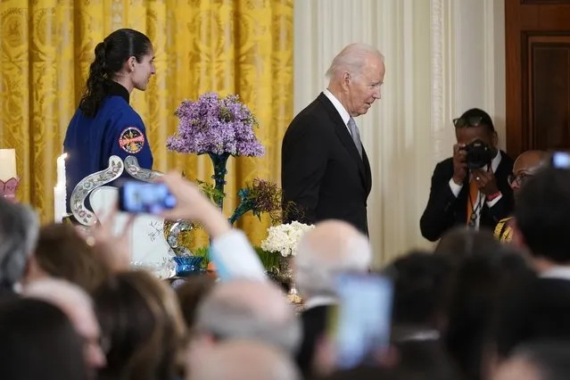 President Joe Biden and NASA astronaut Lt. Col. Jasmin Moghbeli leave the stage during a Nowruz celebration in the East Room of the White House, Monday, March 20, 2023, in Washington. (Photo by Evan Vucci/AP Photo)