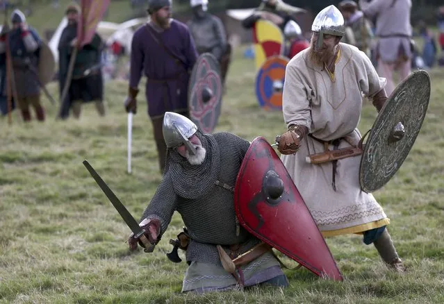 Re-enactors participate in a demonstration before a re-enactment of the the Battle of Hastings on the 950th anniversary of the battle, in Battle, Britain October 15, 2016. (Photo by Neil Hall/Reuters)