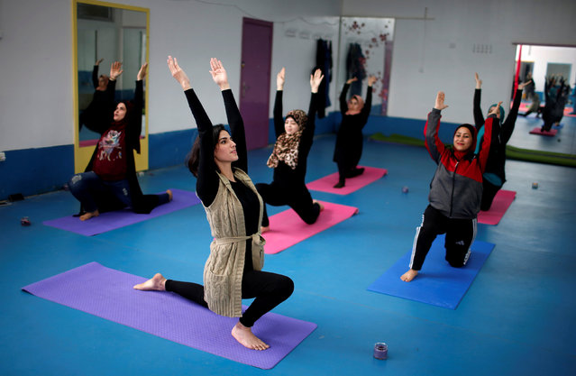 Palestinian women take part in a yoga session in Gaza City March 28, 2018. (Photo by Mohammed Salem/Reuters)